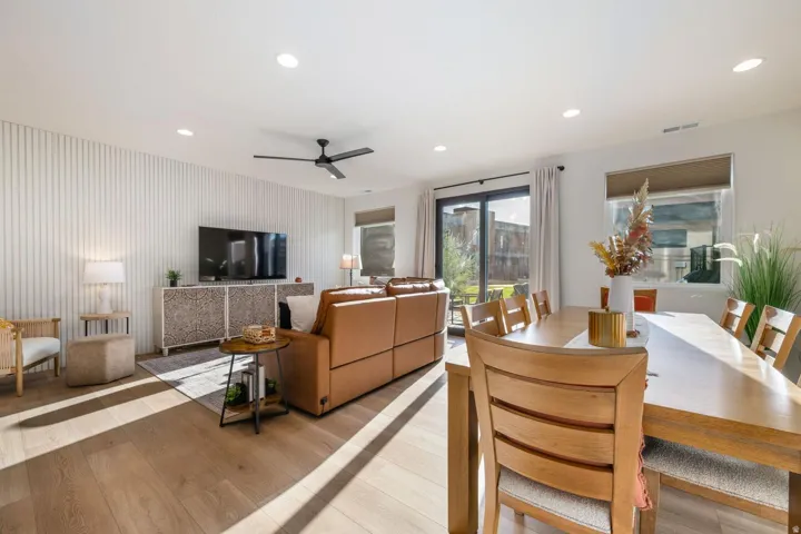 Wood-finish flooring, recessed lighting, and a black ceiling fan