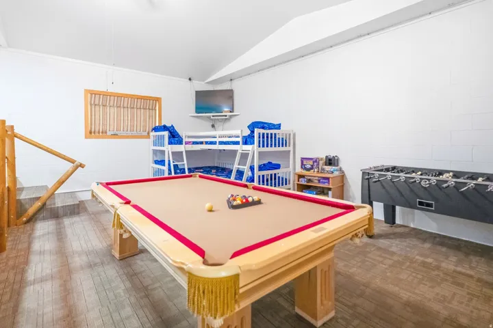 Recreation room featuring a full-size billiard table, wood-finish flooring, and white walls