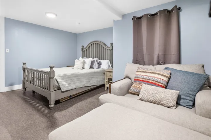 Recessed lighting, light blue wall paint, and gray flooring
