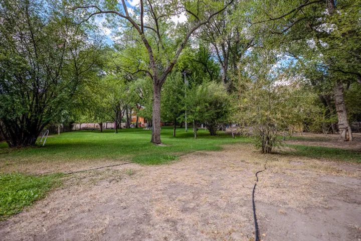 Expansive grounds featuring mature trees and a substantial grassy area