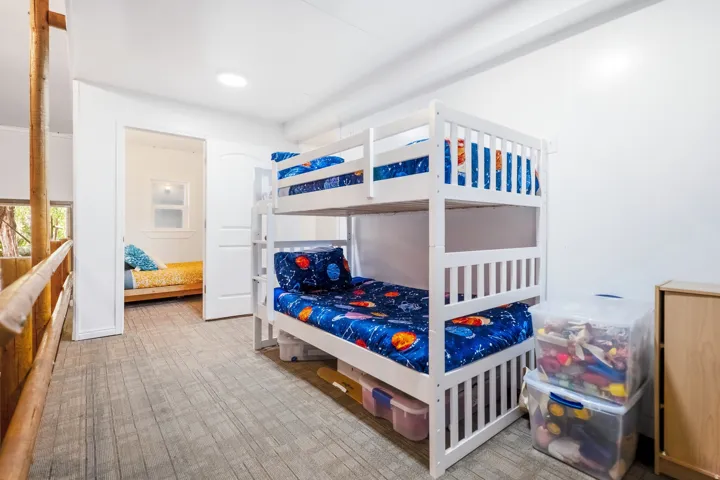 Wood-finish flooring with white walls and a white interior door