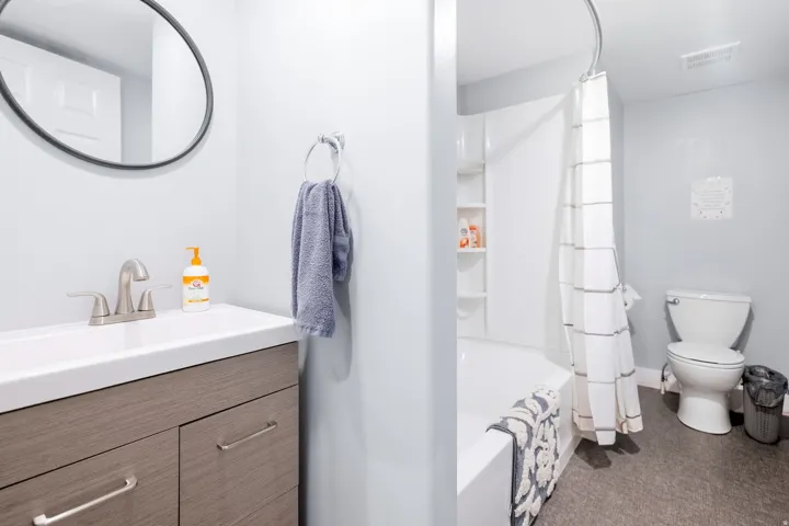Bathroom featuring a wood-finish vanity with an integrated sink and brushed nickel faucet