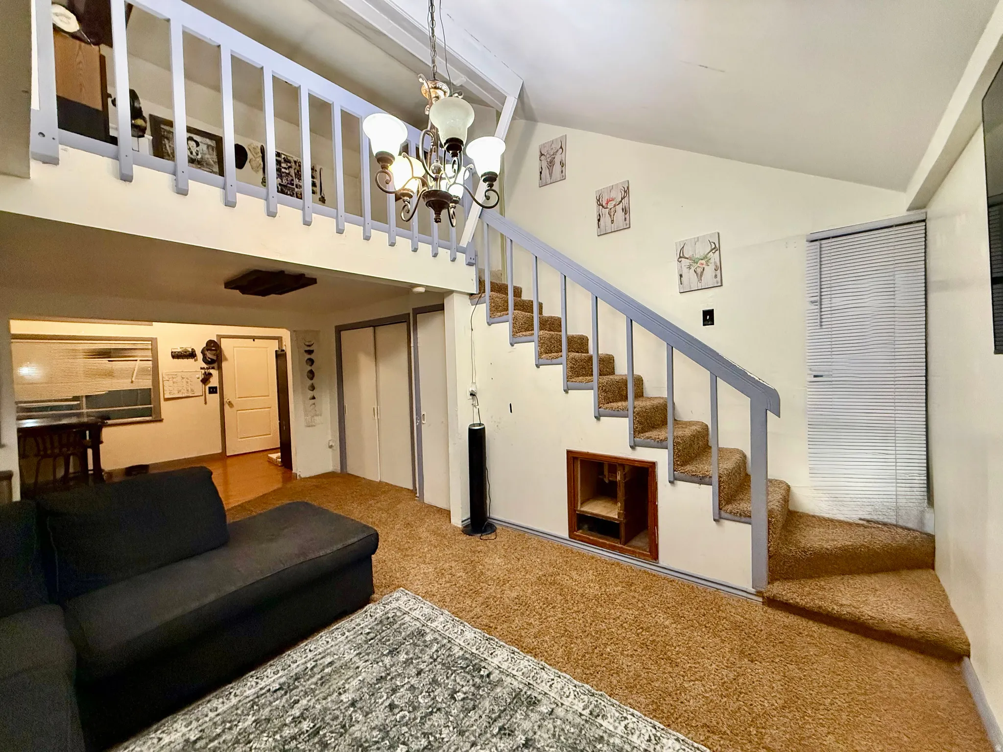 Carpeted stairs leading to a lofted area