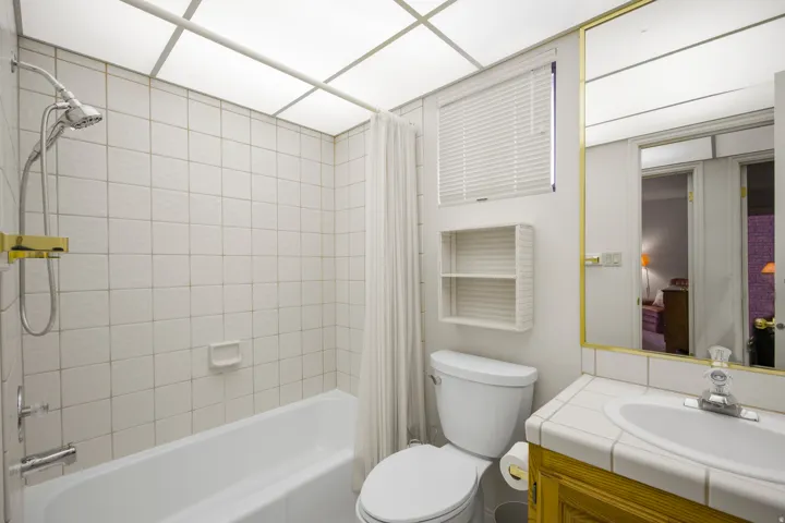White tiled shower and tub combination