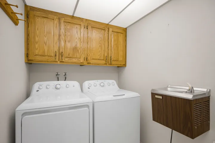 Wood-finish wall cabinets, wall-mounted water dispenser, and washer and dryer hookups
