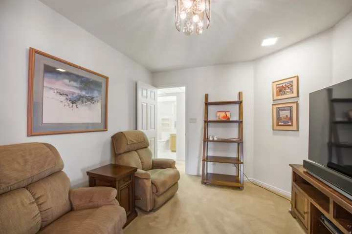 Carpeted floor, white walls, and a recessed ceiling light