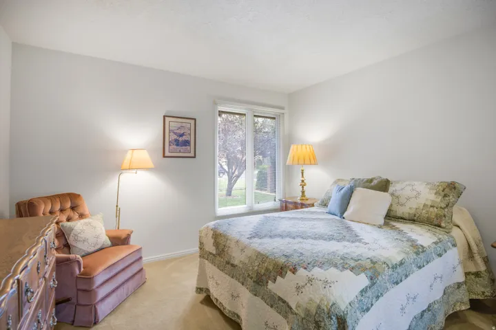 Recessed window with white trim, soft beige carpeting, and neutral wall color