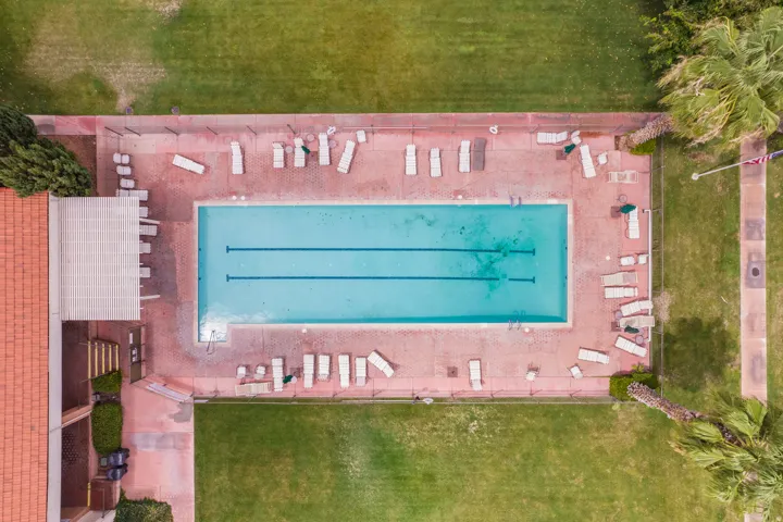 Rectangular swimming pool with lane markers, surrounded by a paver deck