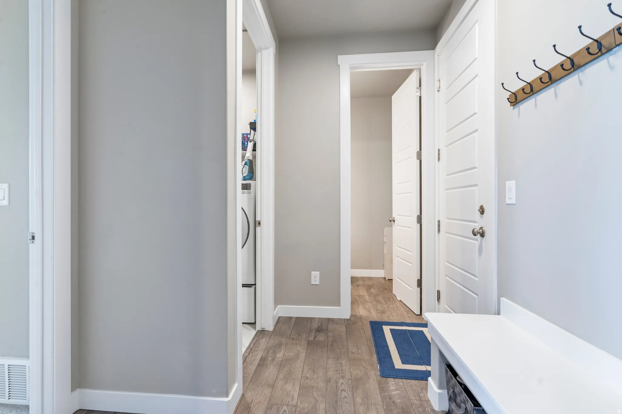 Wood-finish flooring, light gray wall paint, and white trim