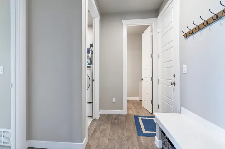 Wood-finish flooring, light gray wall paint, and white trim