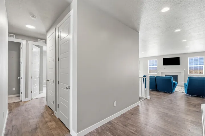 Wood-finish flooring throughout, recessed ceiling lighting, and crisp white trim details