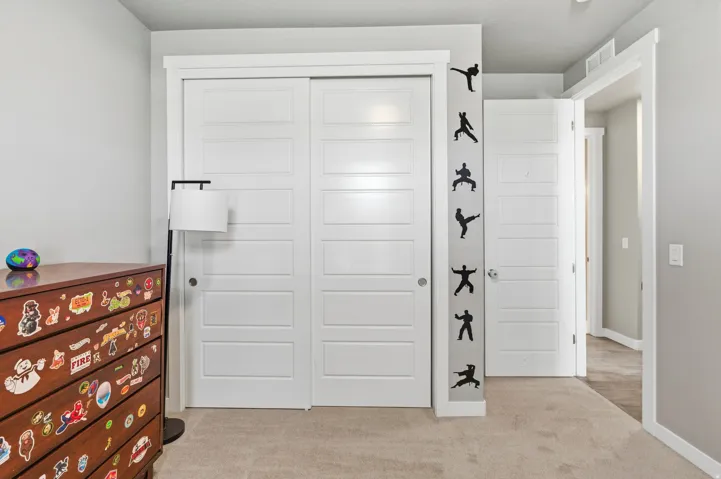 White sliding closet doors with panel detailing