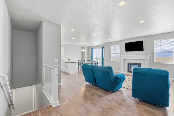 Open-concept living area featuring wood-finish flooring and recessed lighting