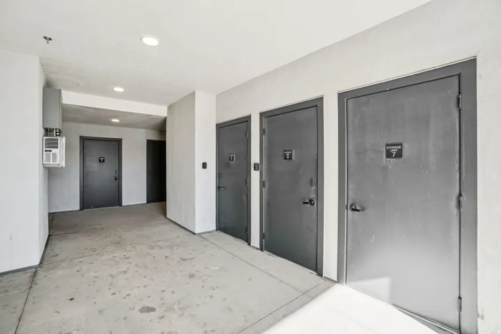 Concrete flooring, recessed lighting, and wall-mounted HVAC unit
