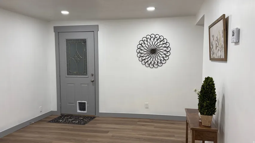 Recessed ceiling lighting illuminates wood-finish flooring