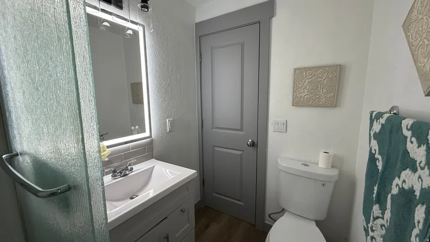Vanity with integrated sink, chrome faucet, and subway tile backsplash