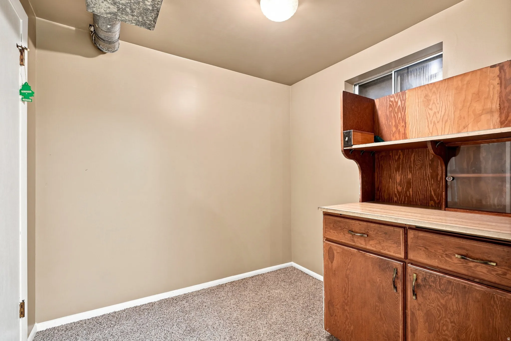 Built-in wood-finish cabinetry with drawers and glass-front doors