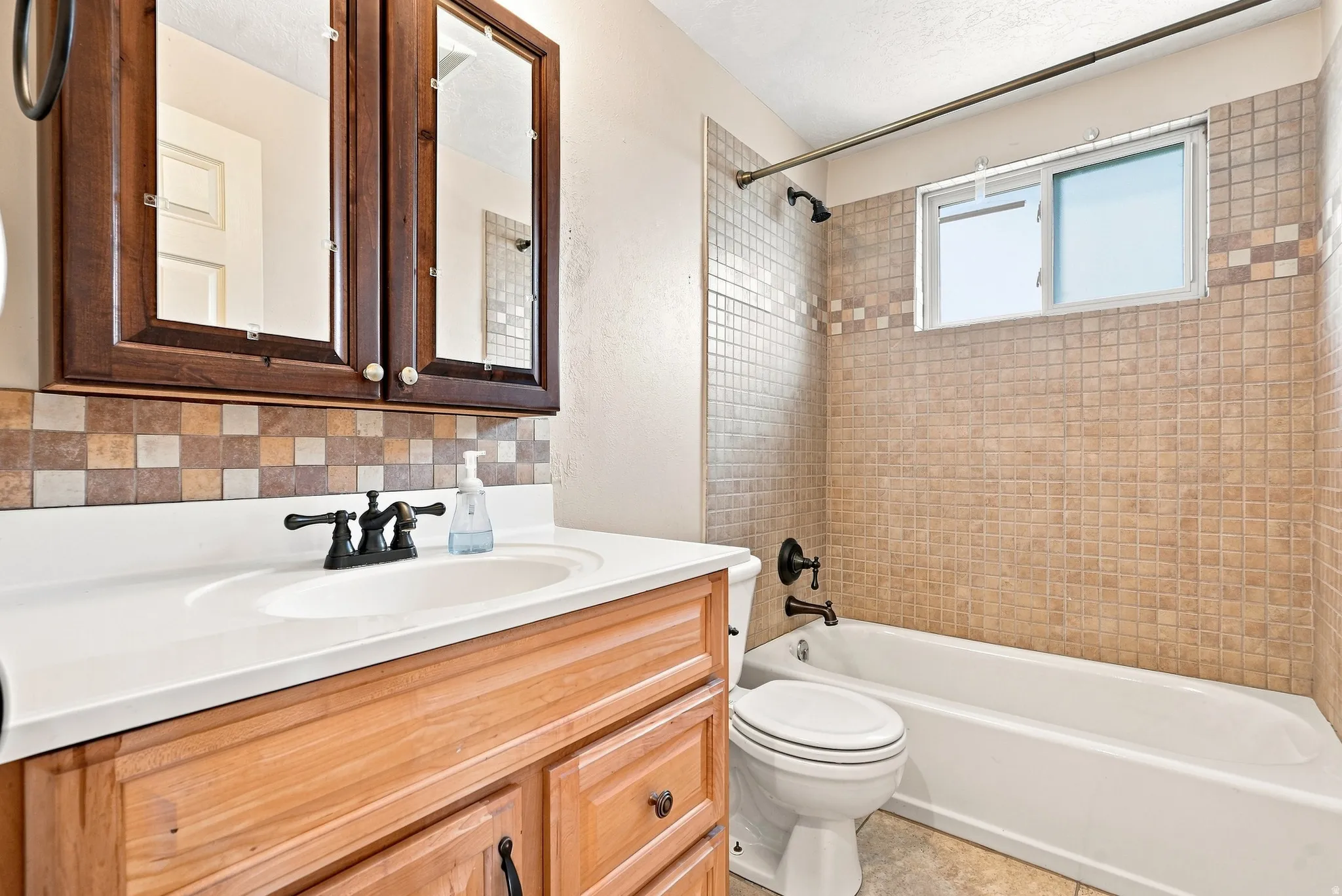 Wood-finish vanity with white countertop and integrated sink