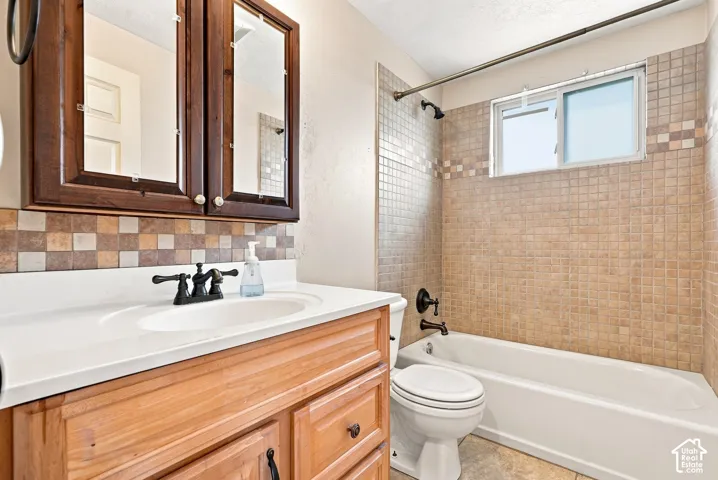 Wood-finish vanity with white countertop and integrated sink