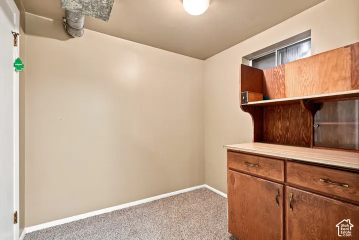 Built-in wood-finish cabinetry with drawers and glass-front doors