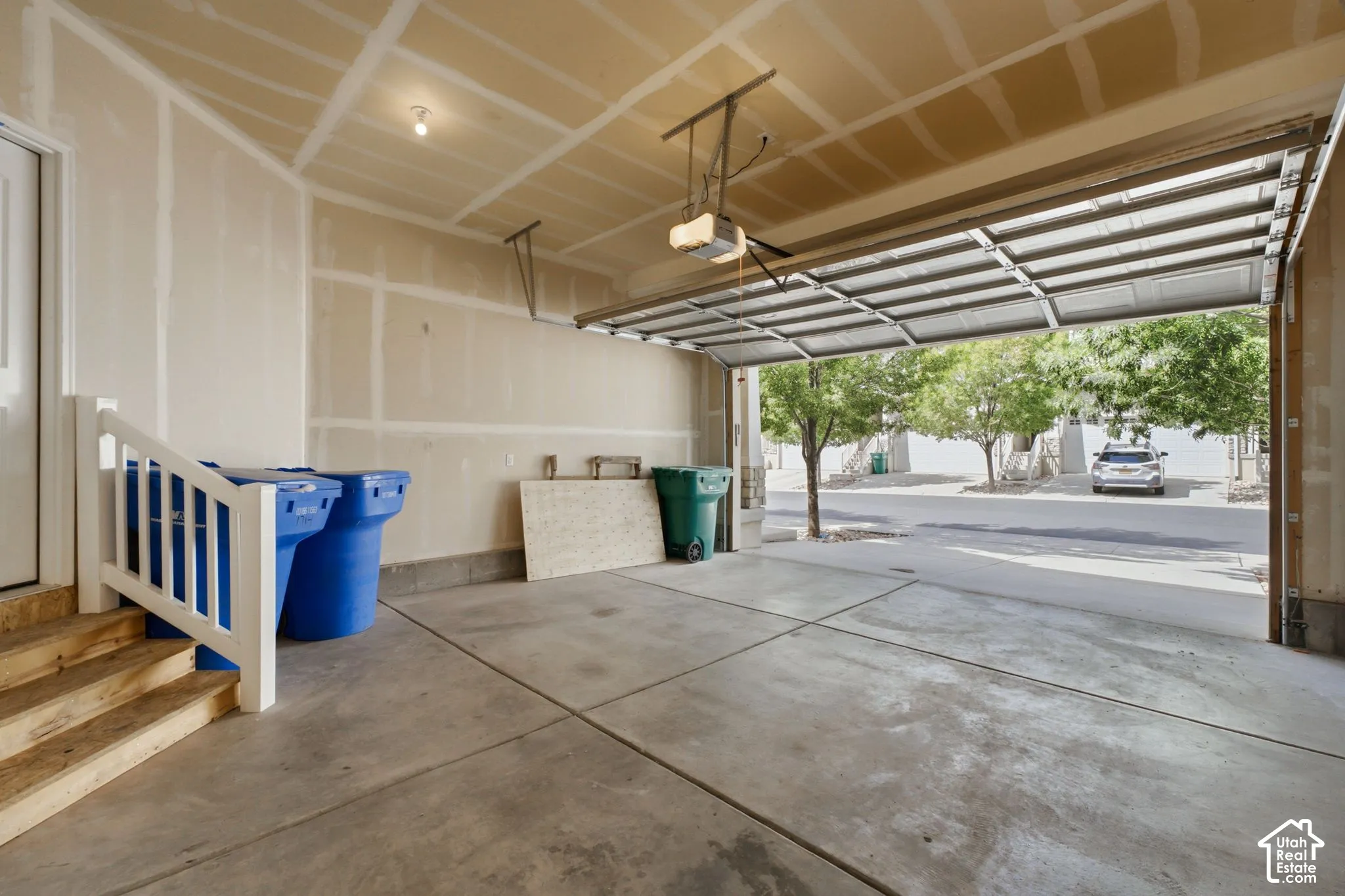 Concrete garage flooring, an automatic garage door opener, and a side access door