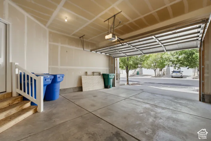 Concrete garage flooring, an automatic garage door opener, and a side access door