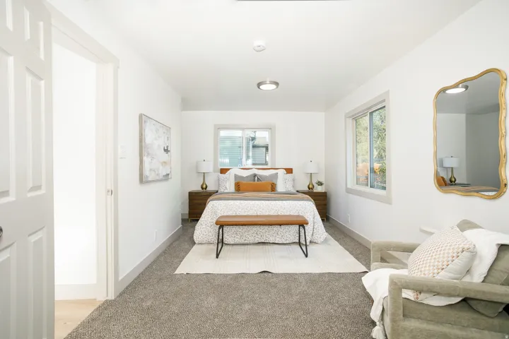 Carpeted flooring, recessed lighting, and dual windows with white trim