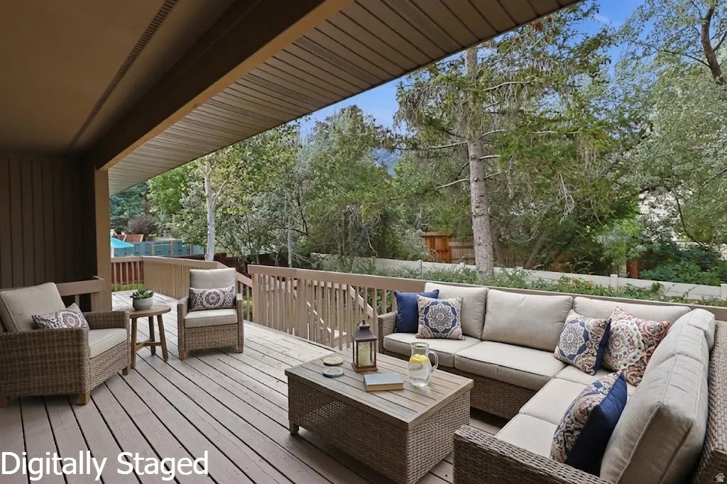 Expansive covered deck with wood-finish flooring and wood railing