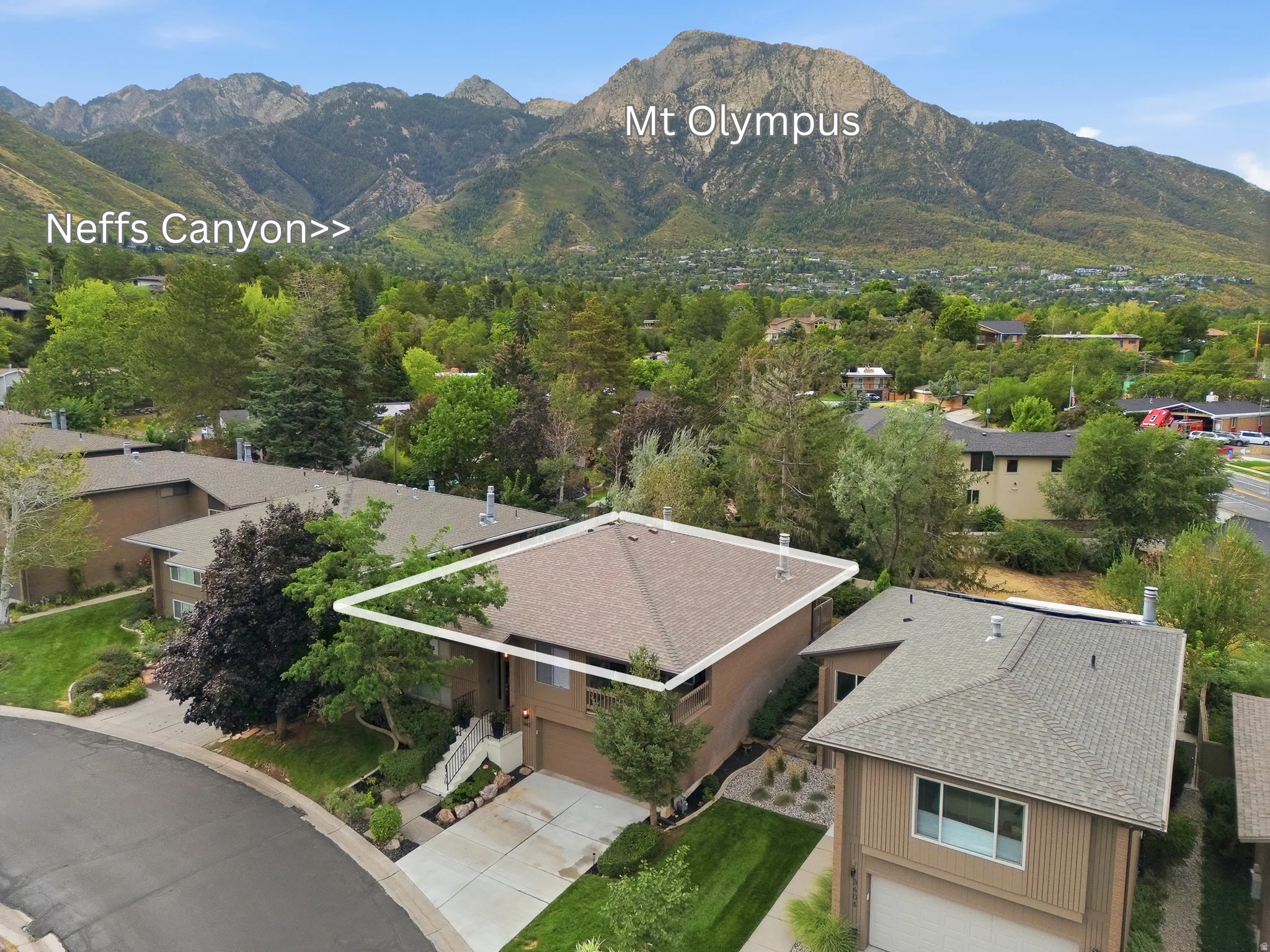 Pitched roofline, attached garage, paved driveway, mature landscaping, cul-de-sac street