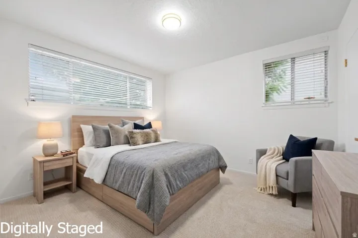 Plush carpet flooring, multiple windows with blinds, and recessed lighting