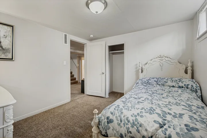 Carpeted room with white walls, a single window, and a flush-mount ceiling light fixture