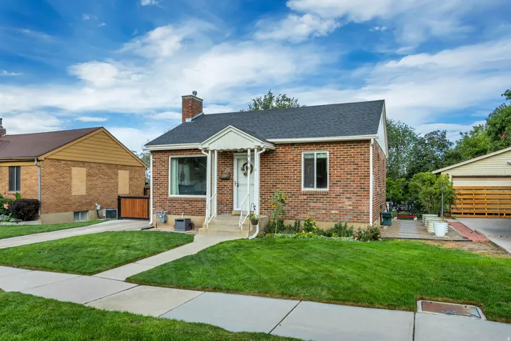 Brick exterior featuring a gabled roof and covered entry