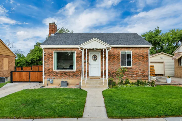 Brick exterior with a gabled roof and covered entry