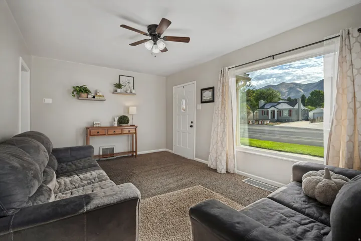 Recessed lighting, ceiling fan, and a large picture window with mountain scenery