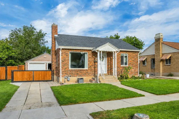 Brick exterior with a dark shingle roof and white trim