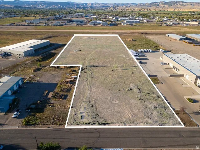 Expansive undeveloped lot with street frontage, featuring a level topography