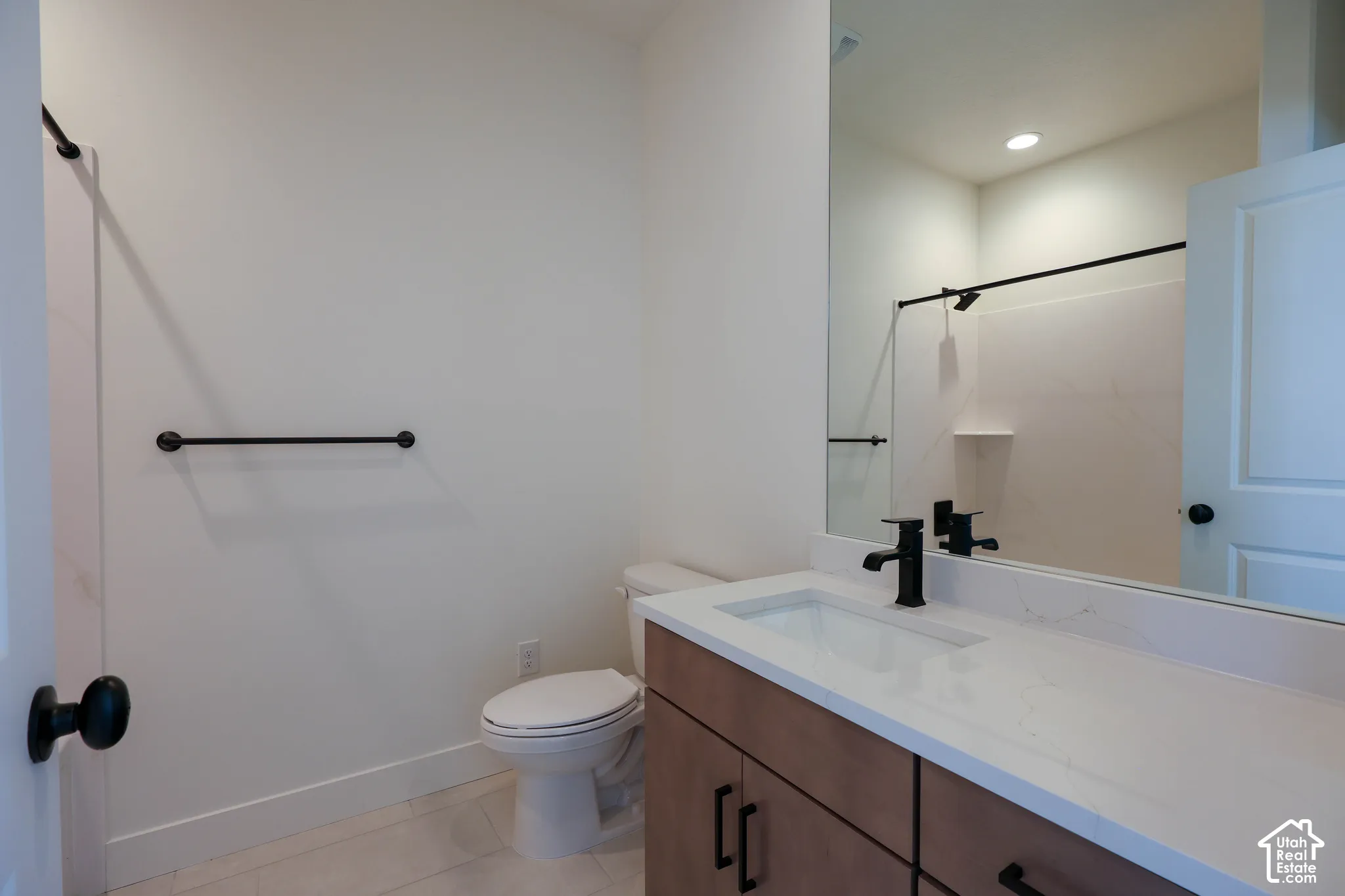 Wood-finish vanity with a white countertop and integrated sink