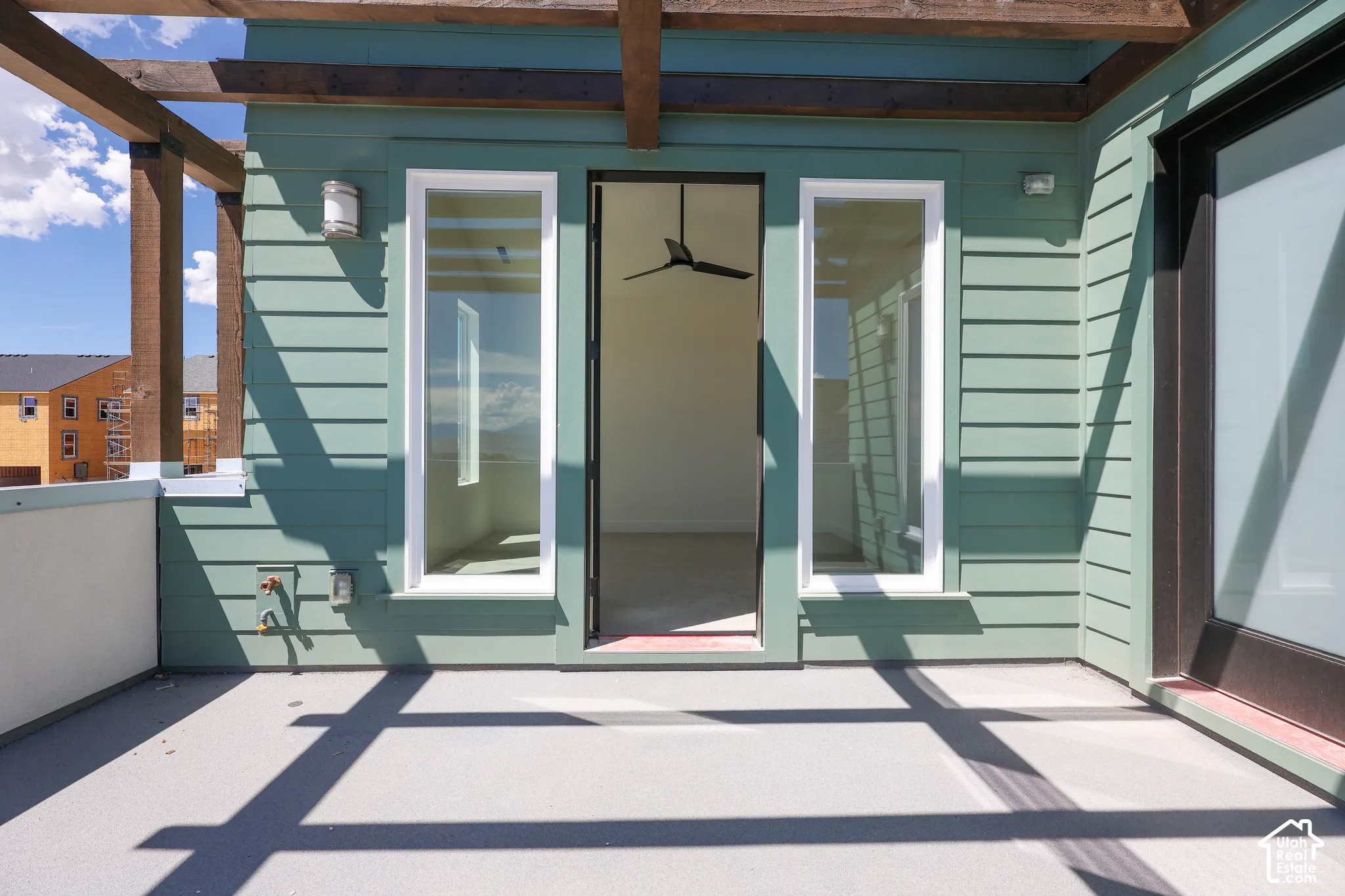 Outdoor balcony off of Primary bedroom with pergola structure, plank siding, and direct access to interior space