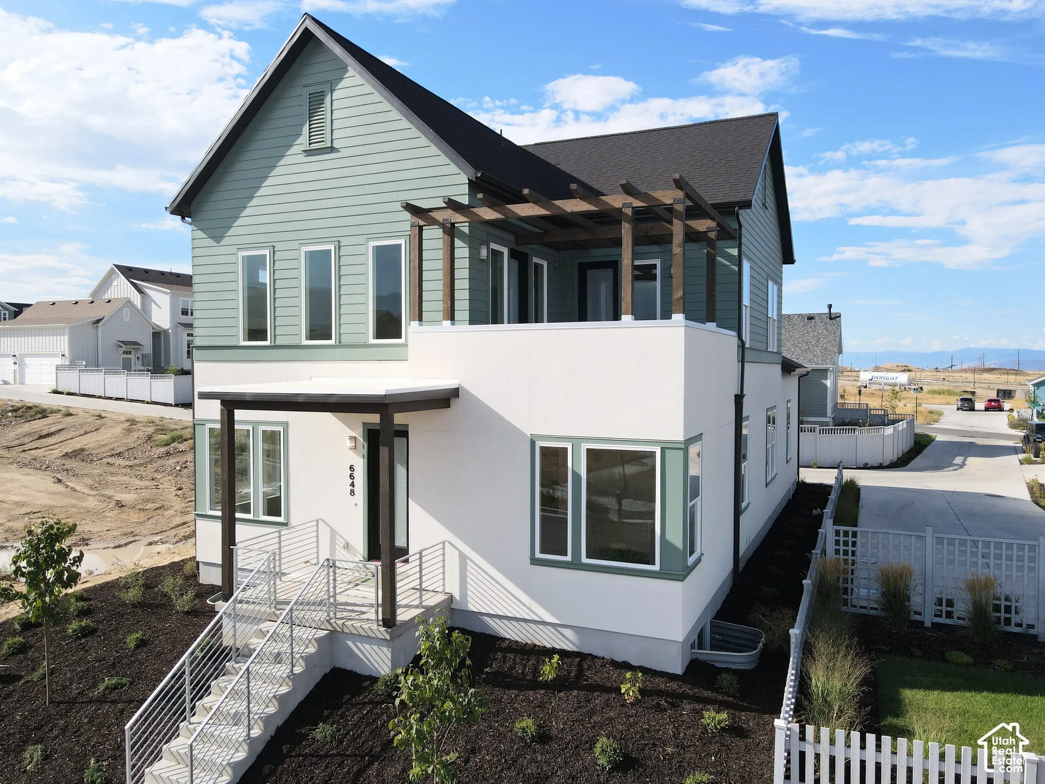Contemporary architectural design featuring a two-story structure with contrasting siding and stucco