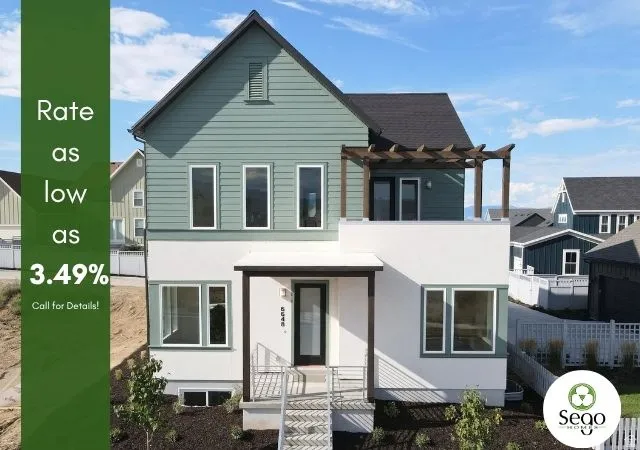 Two-story exterior with teal horizontal siding and white stucco