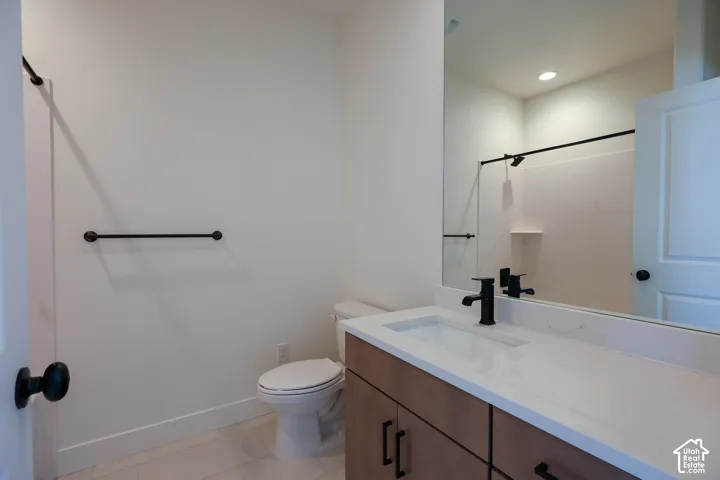 Wood-finish vanity with a white countertop and integrated sink
