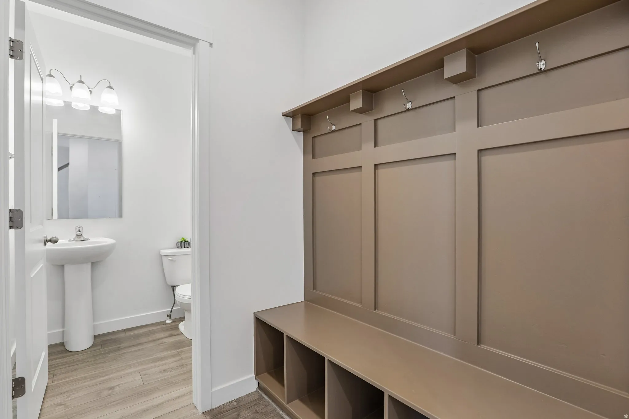 Built-in mudroom bench with storage cubbies and wall hooks