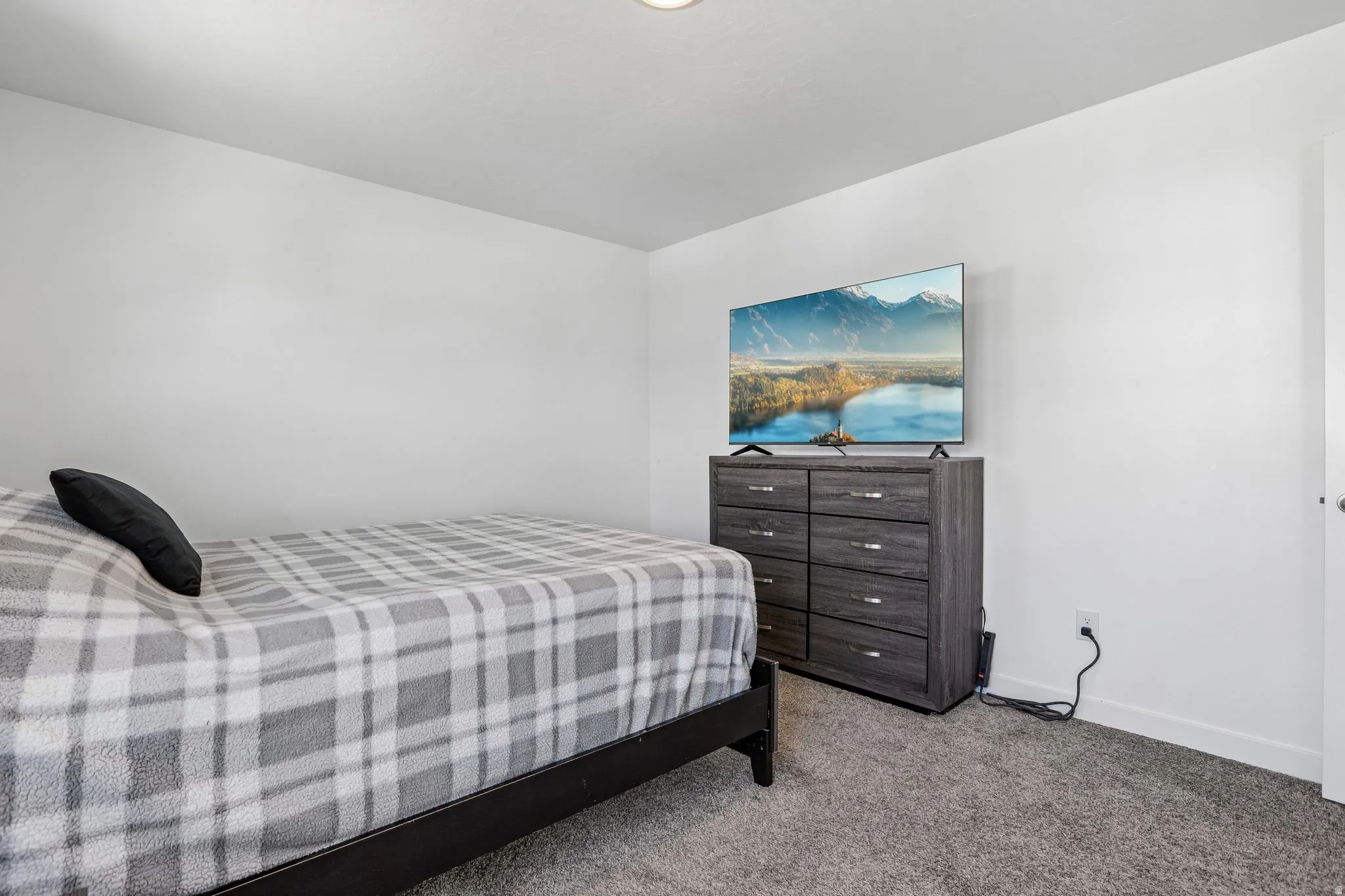 Recessed ceiling lighting, light gray wall paint, and gray carpeting