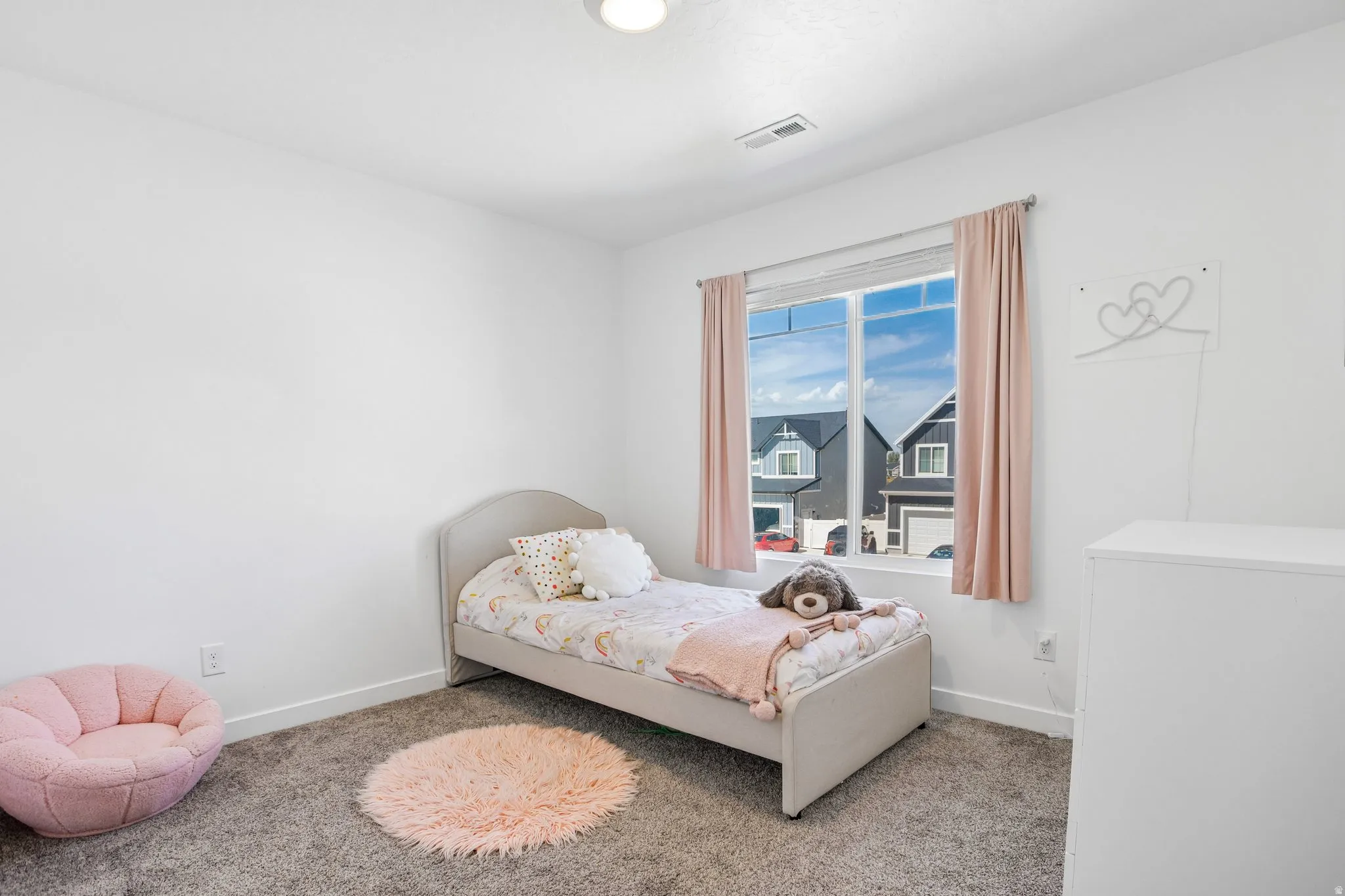 Recessed ceiling light, white walls, double-pane window, and gray carpet flooring