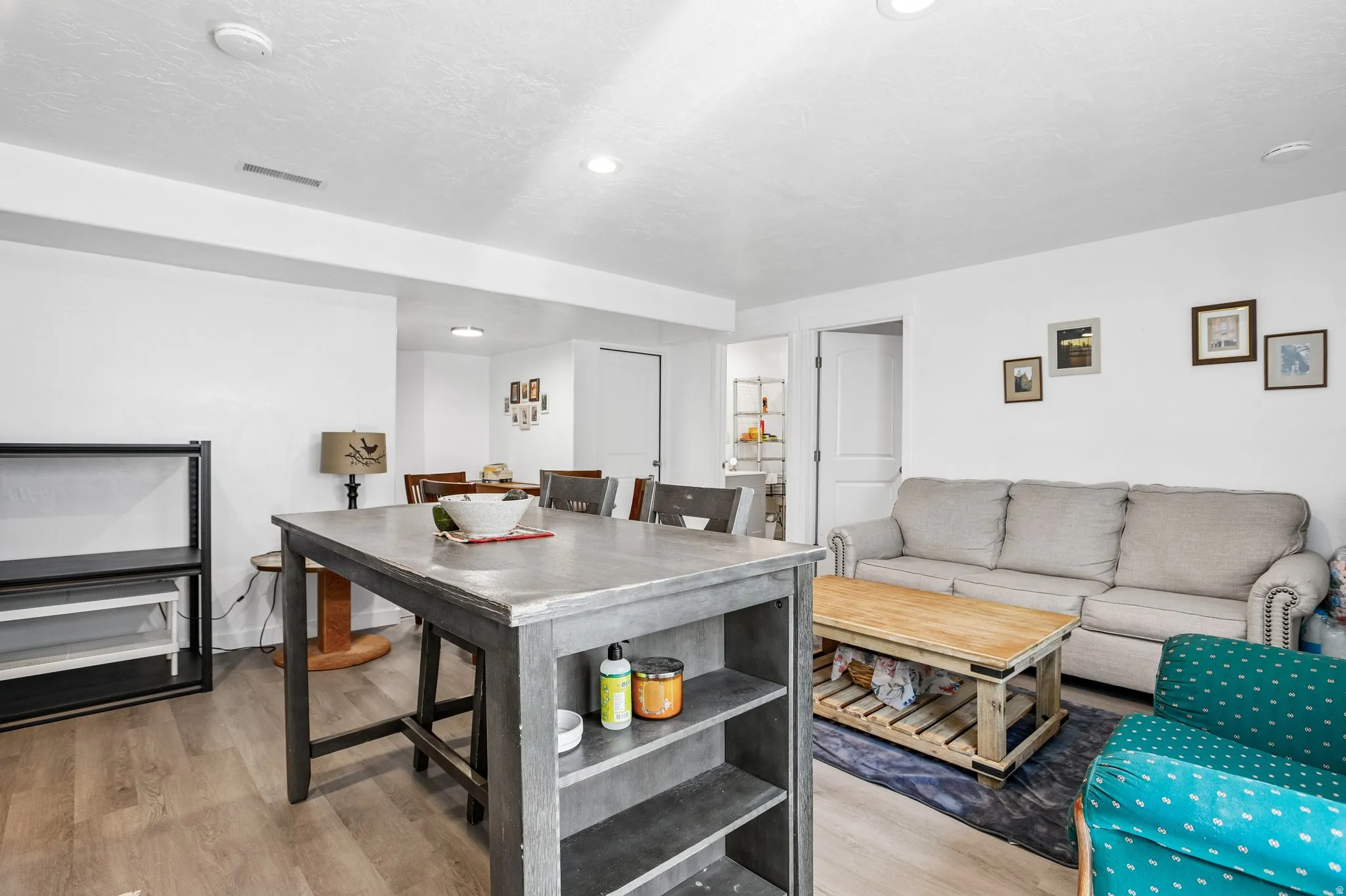 Wood-finish flooring, recessed lighting, and white walls