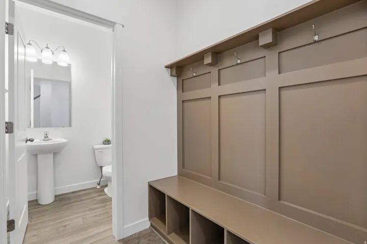 Built-in mudroom bench with storage cubbies and wall hooks