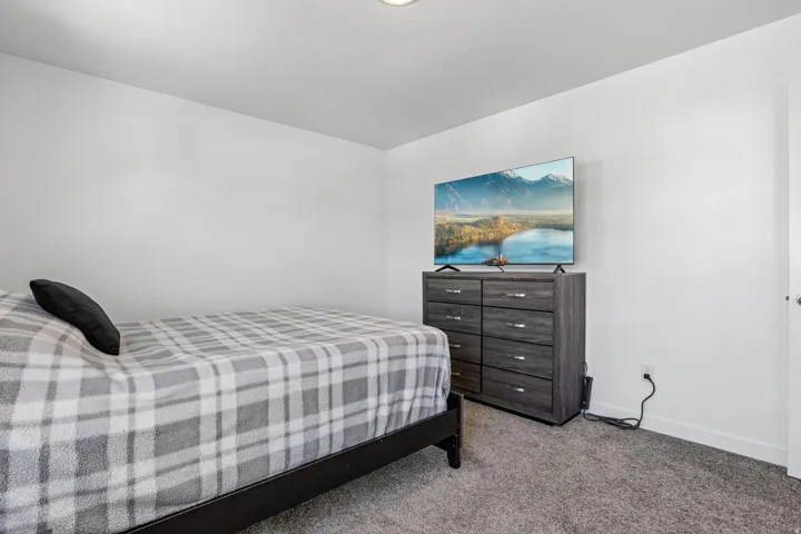 Recessed ceiling lighting, light gray wall paint, and gray carpeting