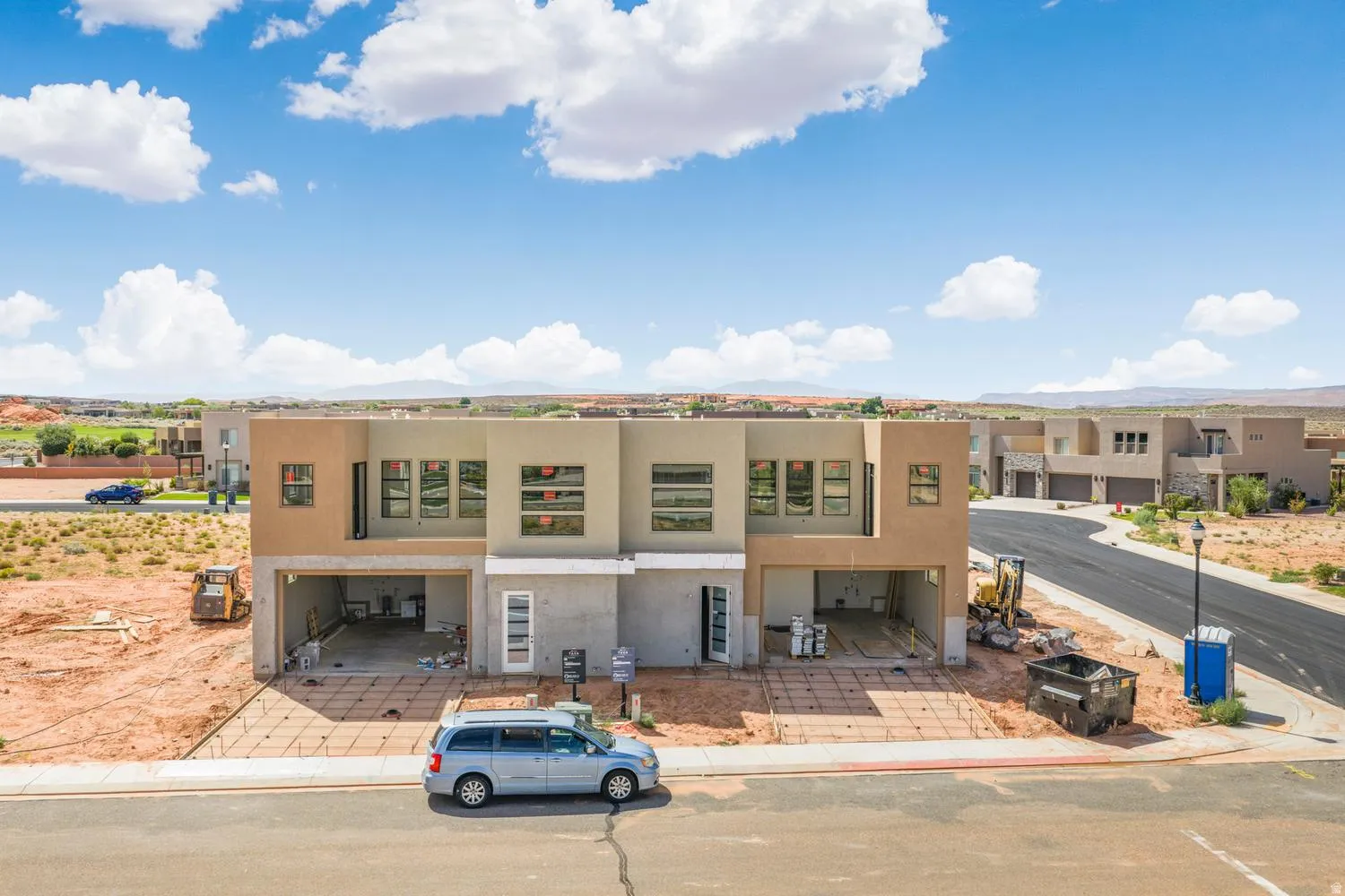Newly constructed modern stucco exterior with multiple windows