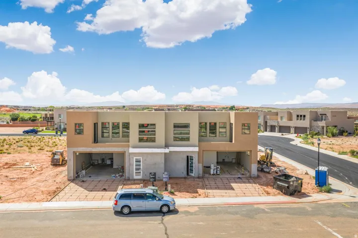 Newly constructed modern stucco exterior with multiple windows