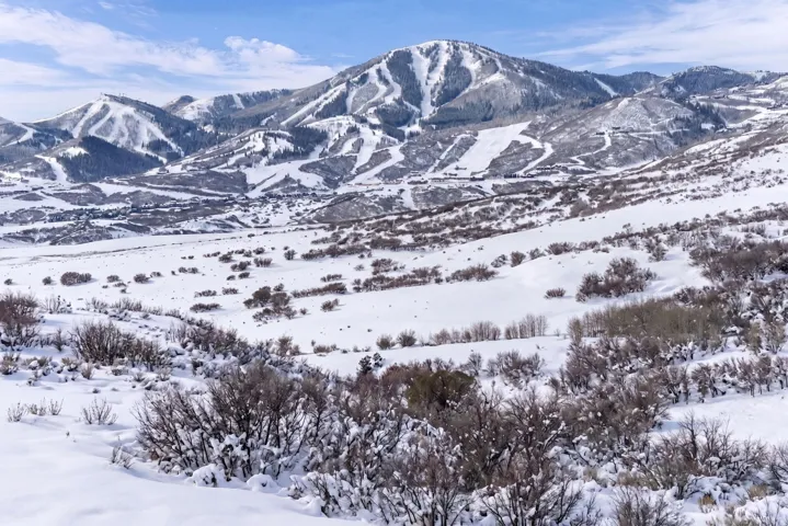 Snow-covered mountain range featuring multiple ski runs and expansive natural terrain